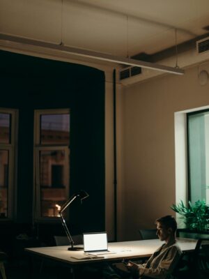 Man in Black Jacket Sitting on Chair