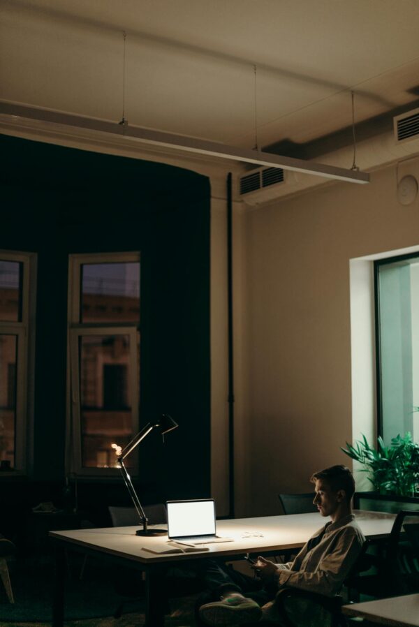 Man in Black Jacket Sitting on Chair