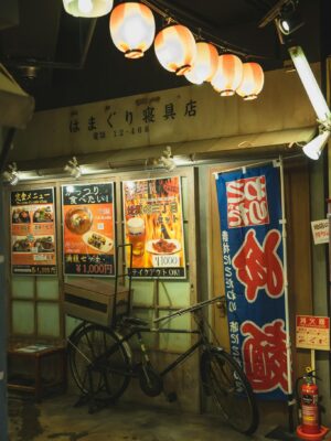 Shining Chinese lanterns above bike parked near cafe