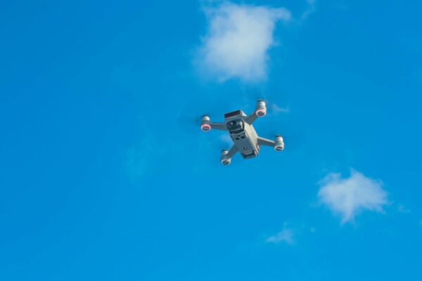 White uav with spinning motors in air